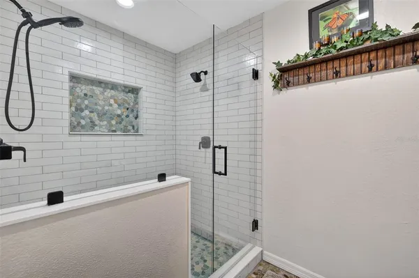 a bathroom with a shower and a window
