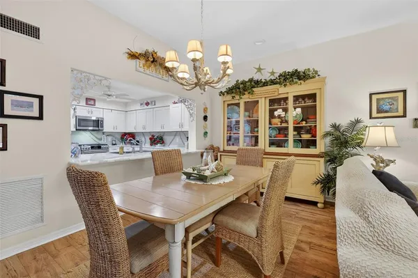 a view of a dining room with furniture and chandelier