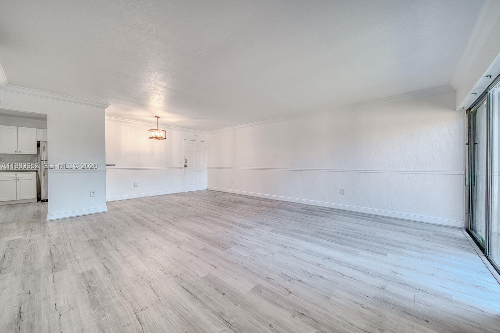 9459 Southwest 76th Street, Unit R5 Miami, FL 33173 - Photo 12 of 33 a view of empty room with wooden floor