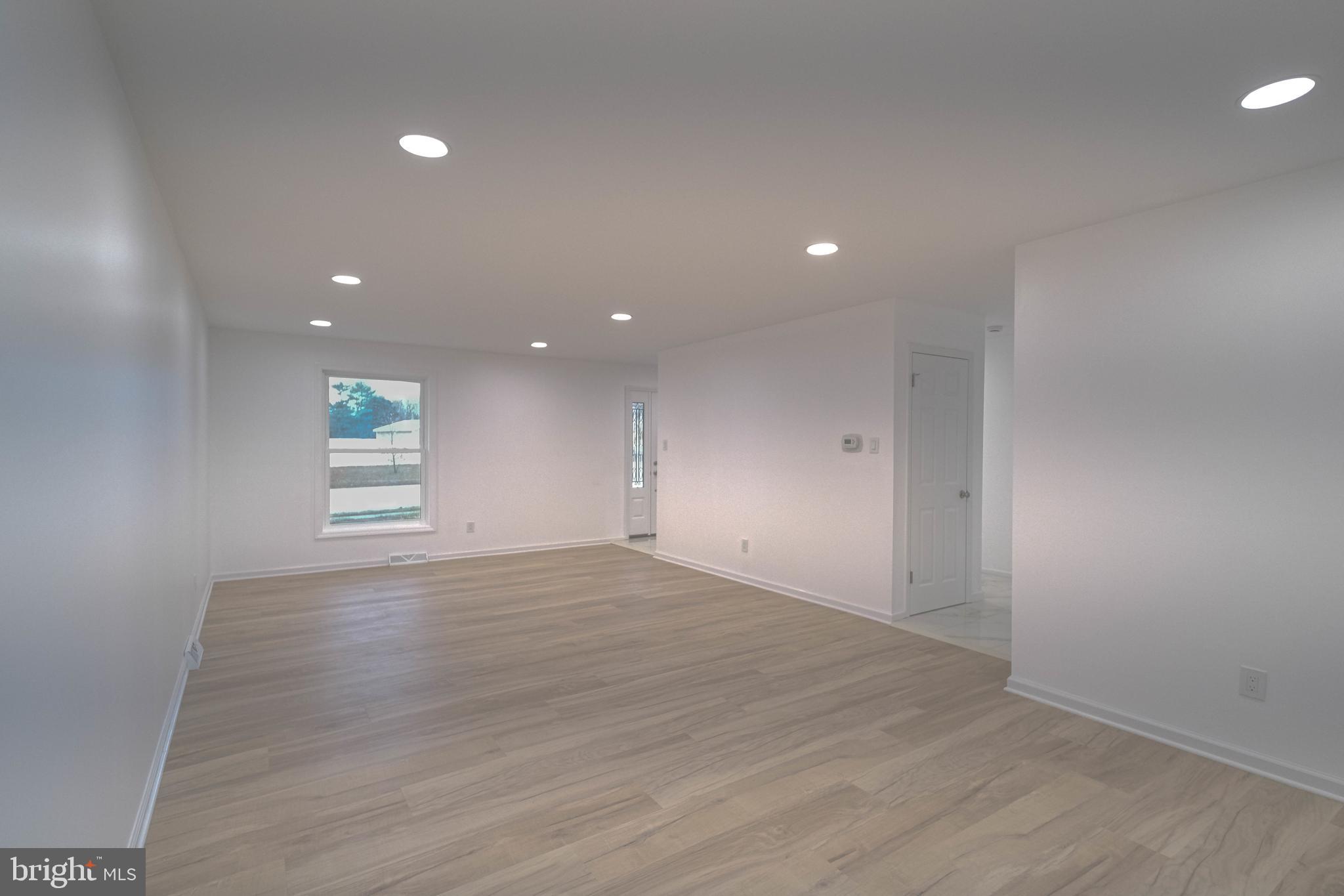 125 North Shore Road Marmora, NJ 08223 - Photo 11 of 27 an empty room with wooden floor and windows