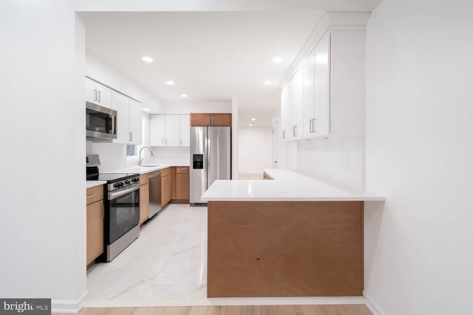 125 North Shore Road Marmora, NJ 08223 - Photo 5 of 27 a large kitchen with a large counter top stainless steel appliances and cabinets
