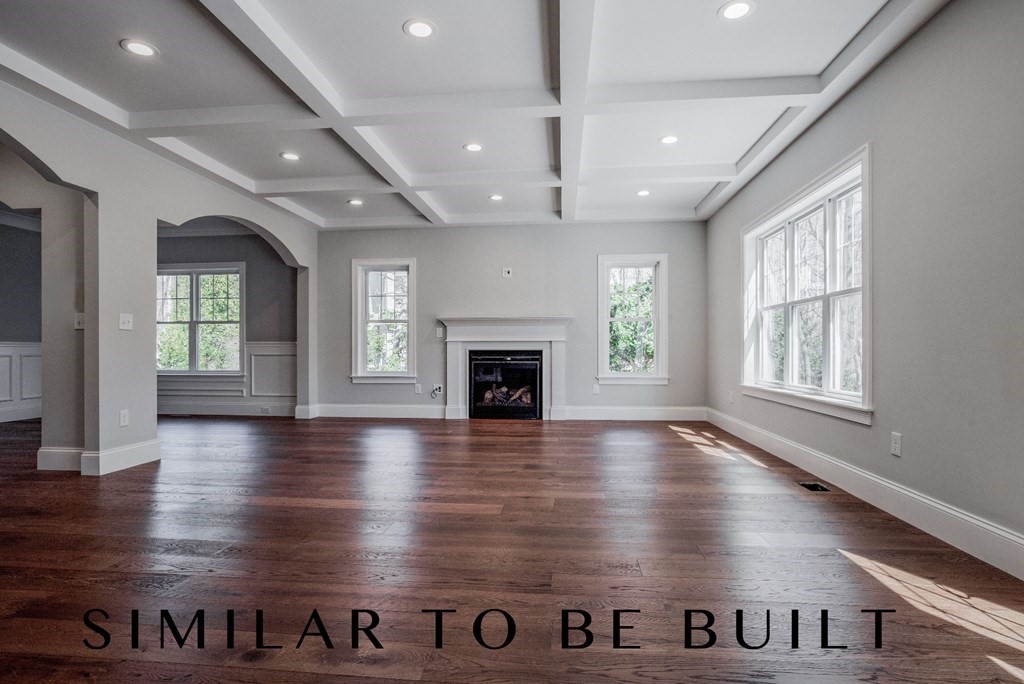 36 Wellesley Road Natick, MA 01760 - Photo 5 of 6 an empty room with wooden floor and a fireplace
