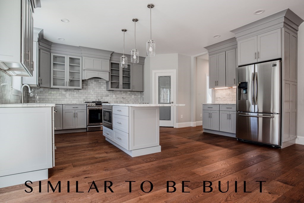 36 Wellesley Road Natick, MA 01760 - Photo 6 of 6 a kitchen with kitchen island a counter top space a sink stainless steel appliances and cabinets