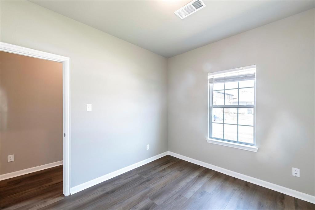 2069 Hartley Drive Forney, TX 75126 - Photo 12 of 27 an empty room with wooden floor and windows