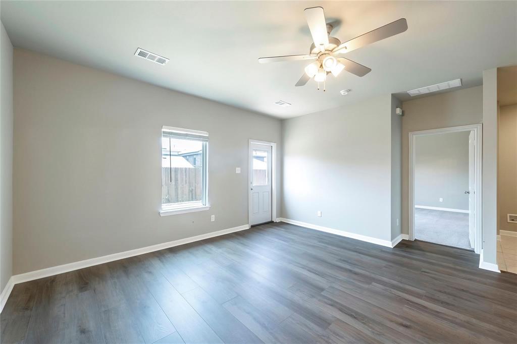 2069 Hartley Drive Forney, TX 75126 - Photo 16 of 27 a view of an empty room with wooden floor and a window