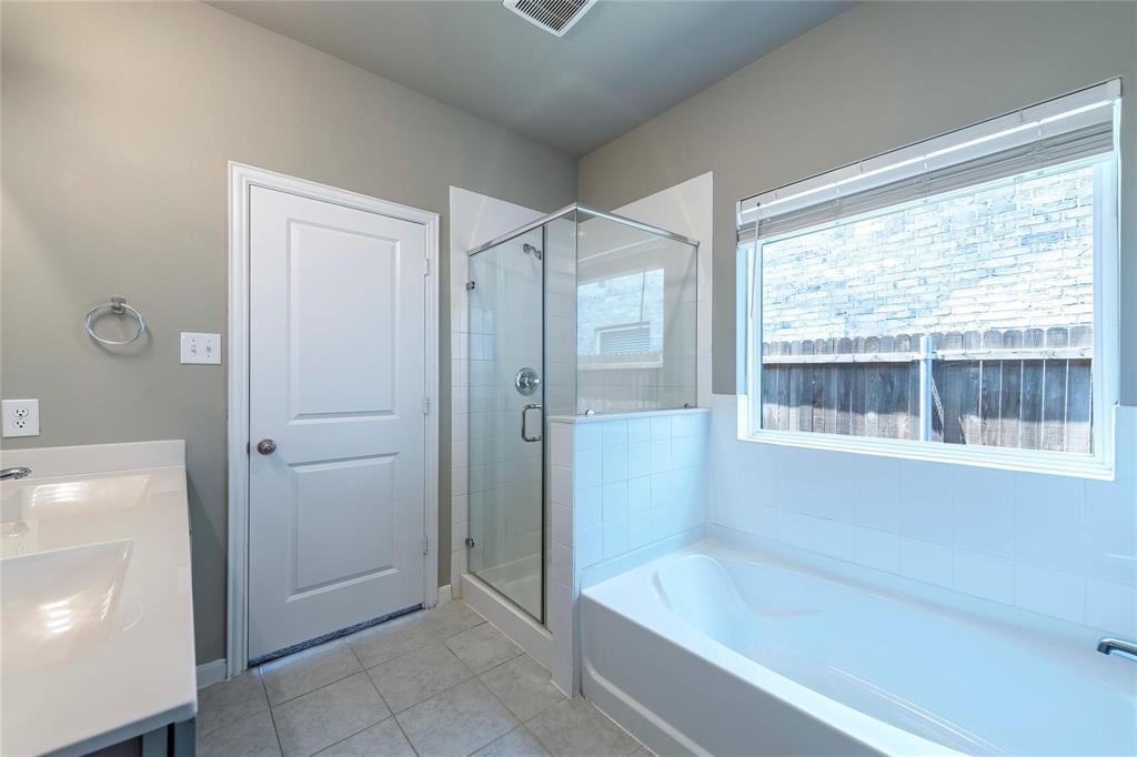 2069 Hartley Drive Forney, TX 75126 - Photo 20 of 27 a bathroom with a bathtub and a shower