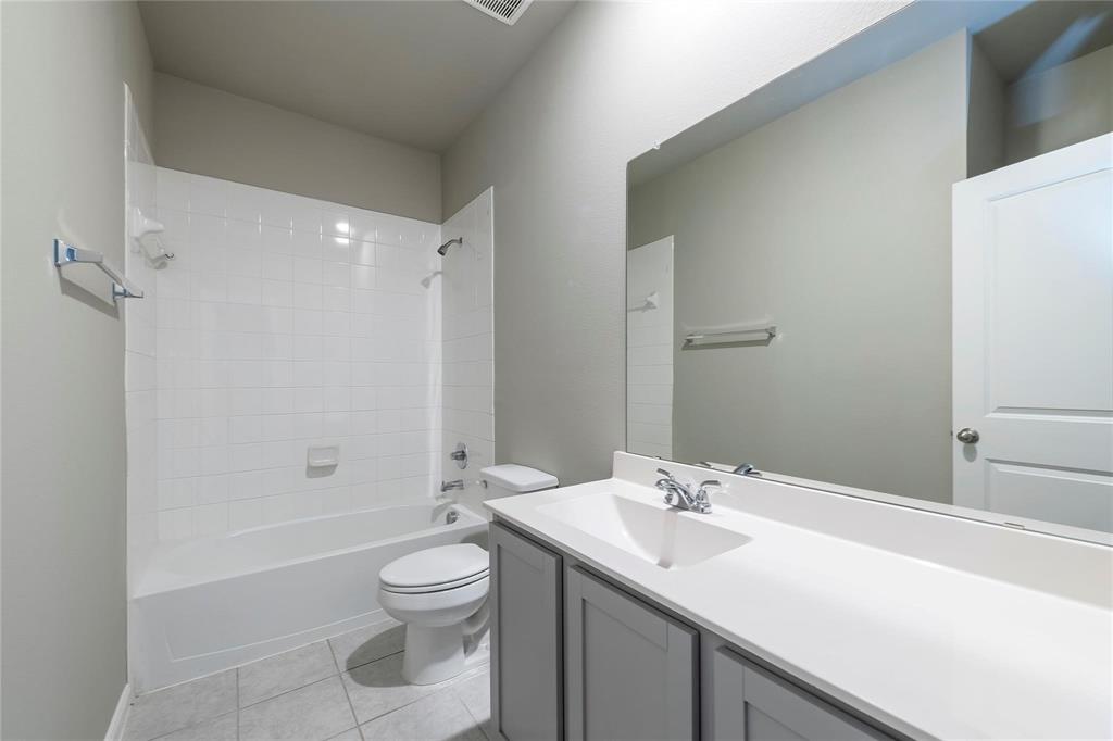 2069 Hartley Drive Forney, TX 75126 - Photo 21 of 27 a bathroom with a sink a toilet and shower