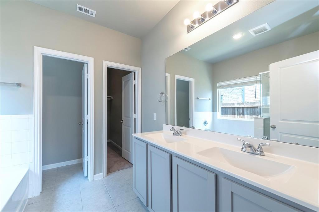 2069 Hartley Drive Forney, TX 75126 - Photo 22 of 27 a bathroom with a sink and a mirror