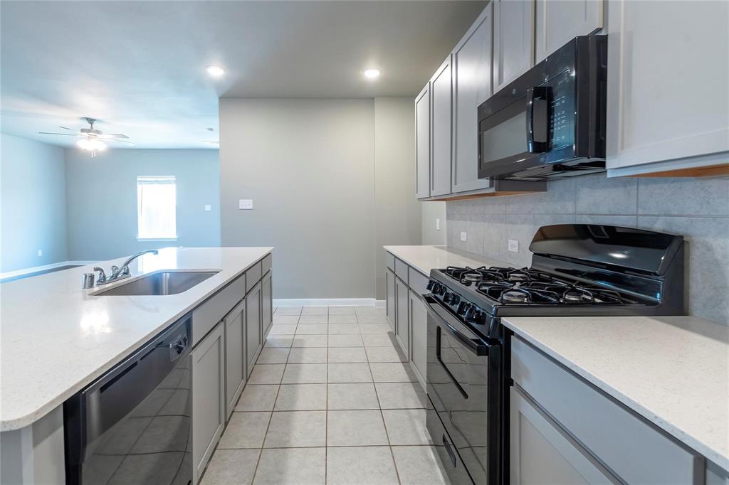2069 Hartley Drive Forney, TX 75126 - Photo 6 of 27 a kitchen with stainless steel appliances a sink a stove and cabinets