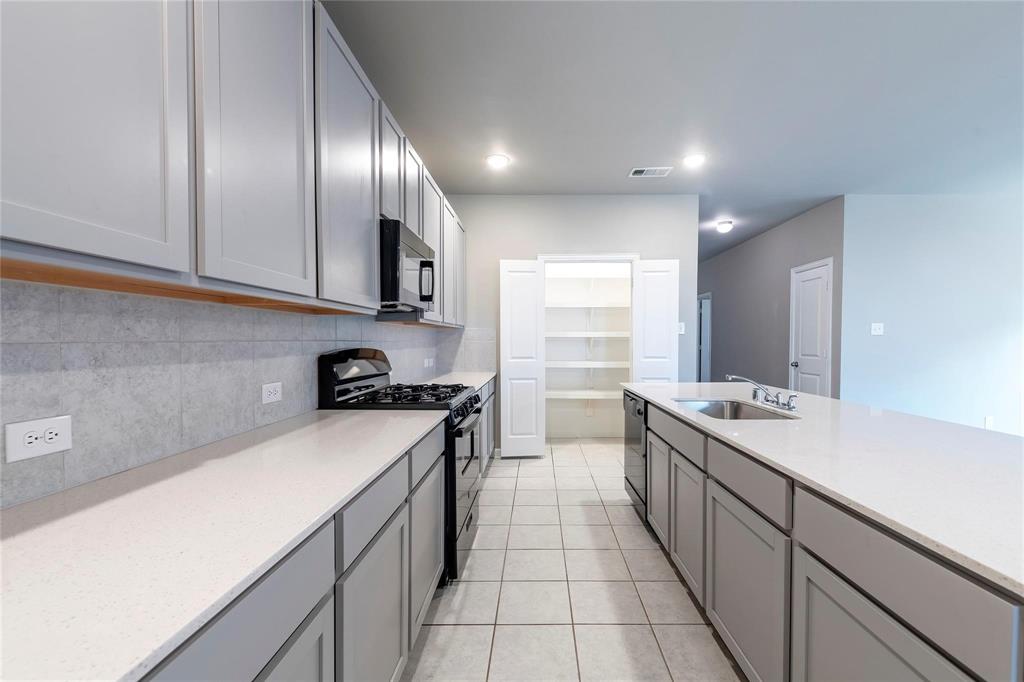 2069 Hartley Drive Forney, TX 75126 - Photo 7 of 27 a kitchen with a sink and a stove top oven
