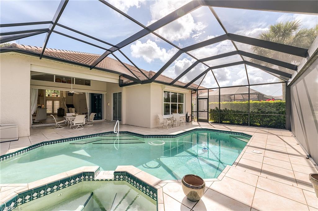 9156 Spring Run Boulevard Estero, FL 34135 - Photo 24 of 34 a view of a swimming pool with a patio