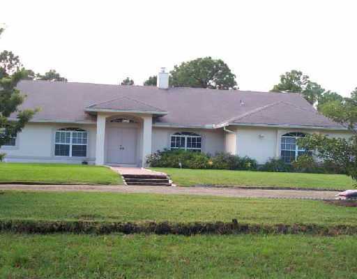13418 76th Road North West Palm Beach, FL 33412 - Photo 1 of 1 a front view of a house with a yard and garage