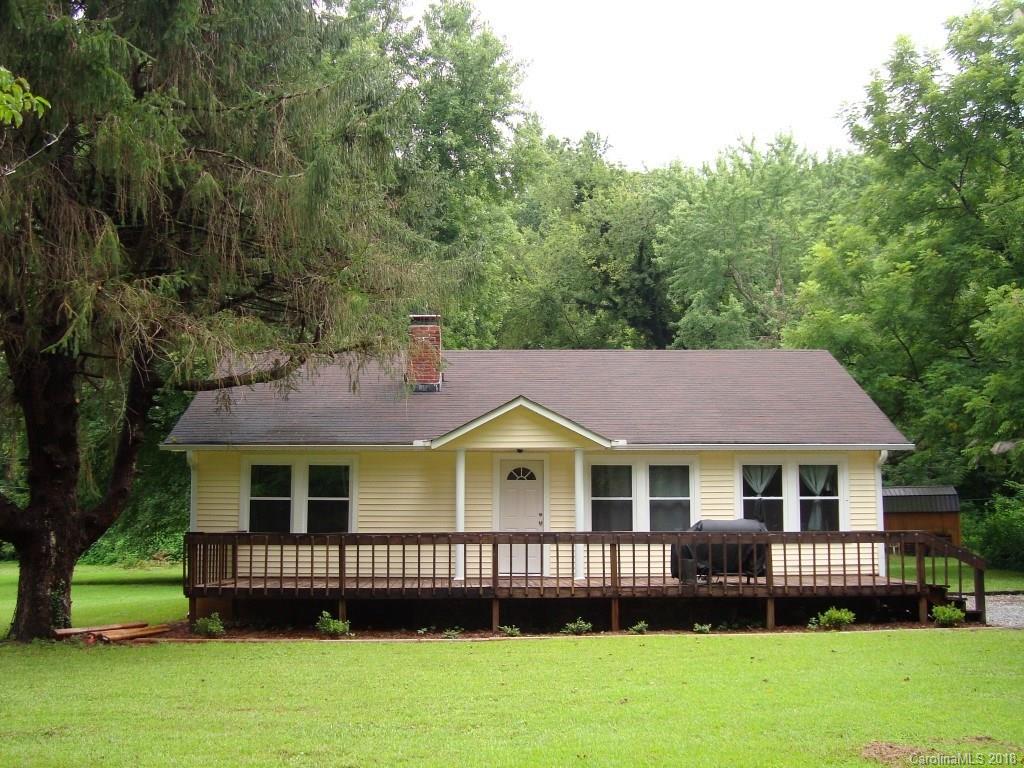 85 Wall Road Tryon, NC 28782 - Photo 1 of 22 a front view of a house with a garden