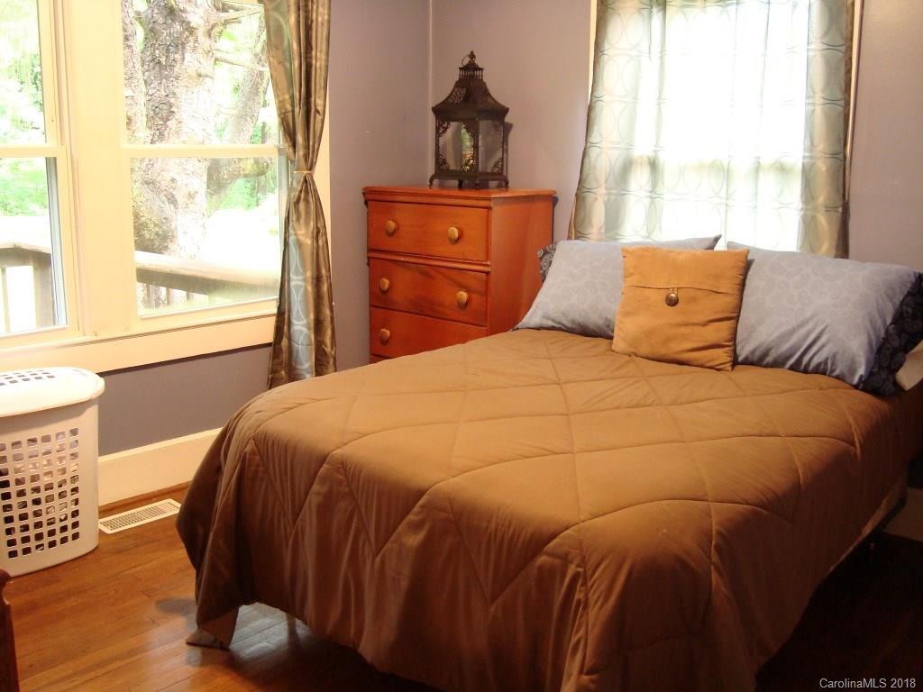 85 Wall Road Tryon, NC 28782 - Photo 11 of 22 a bedroom with a bed and wooden floor