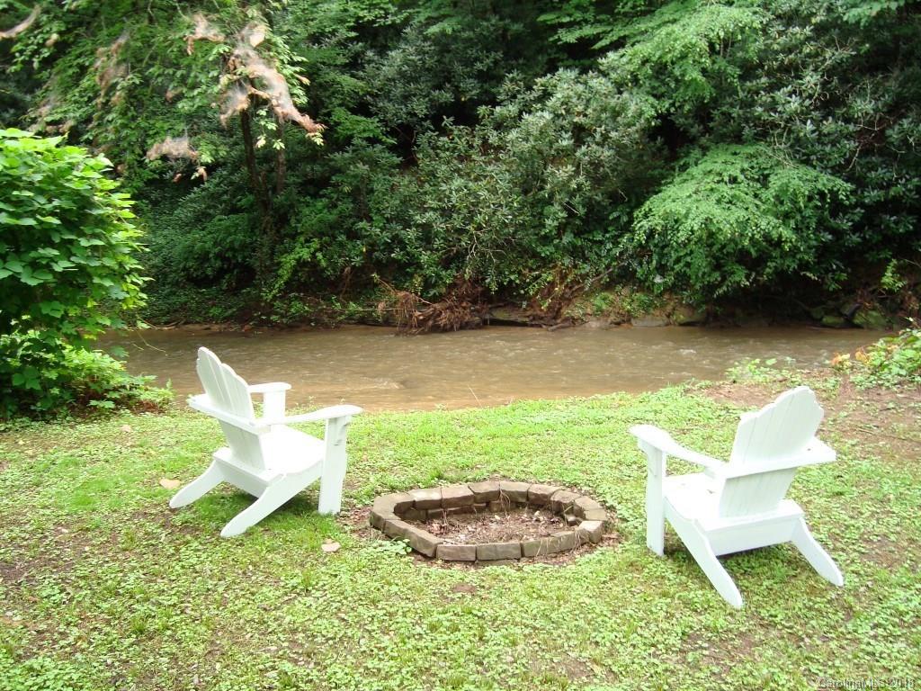 85 Wall Road Tryon, NC 28782 - Photo 22 of 22 a view of a wooden chair and fire pit in the yard