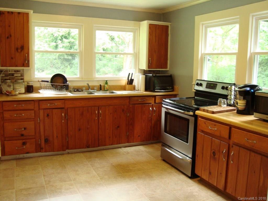 85 Wall Road Tryon, NC 28782 - Photo 7 of 22 a kitchen with stainless steel appliances granite countertop a stove a sink dishwasher and a microwave