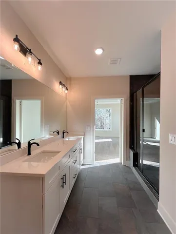 a bathroom with a double vanity sink and a mirror