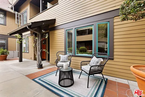 a view of patio with couple of chairs and a table