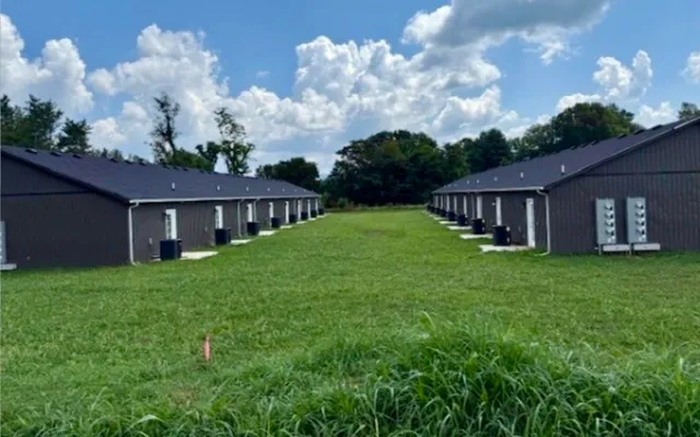 a view of a house with backyard and garden