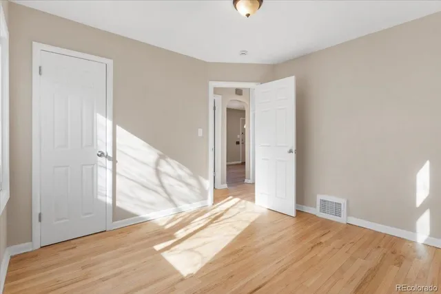 a view of a livingroom with wooden floor and a ceiling fan