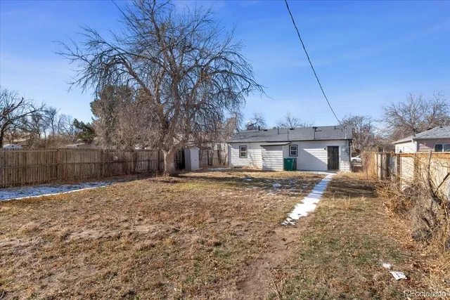 a view of a house with a yard and tree s