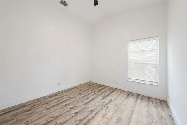 a view of an empty room and wooden floor