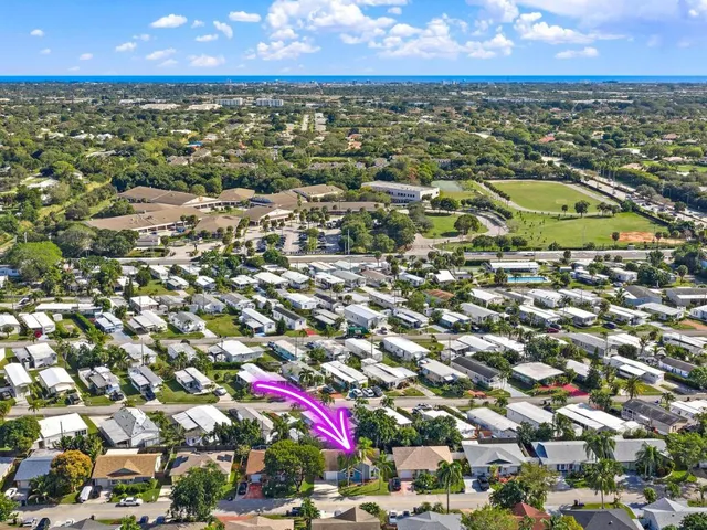 an aerial view of residential houses with outdoor space