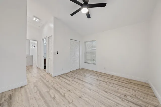 a view of a room with wooden floor and white walls