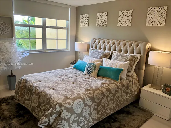 a bedroom with a bed and a lamp