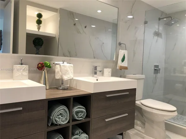 a bathroom with a sink toilet and shower