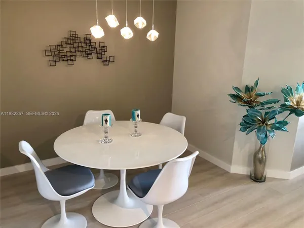 a dining room with furniture and wooden floor
