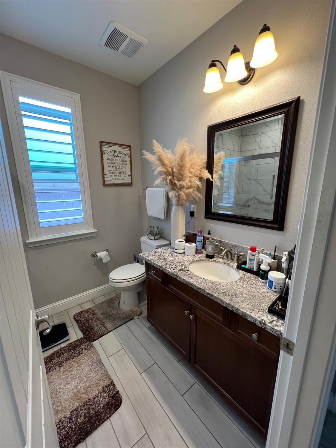 889 Coloma Place Madera, CA 93637 - Photo 27 of 61 a bathroom with a double vanity sink mirror and toilet