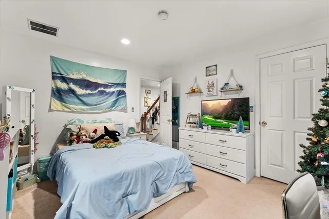 a bedroom with furniture and a flat screen tv