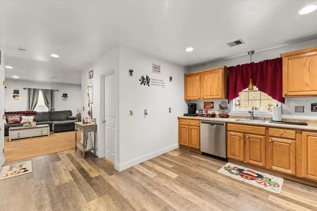 a kitchen with stainless steel appliances granite countertop a refrigerator sink and cabinets