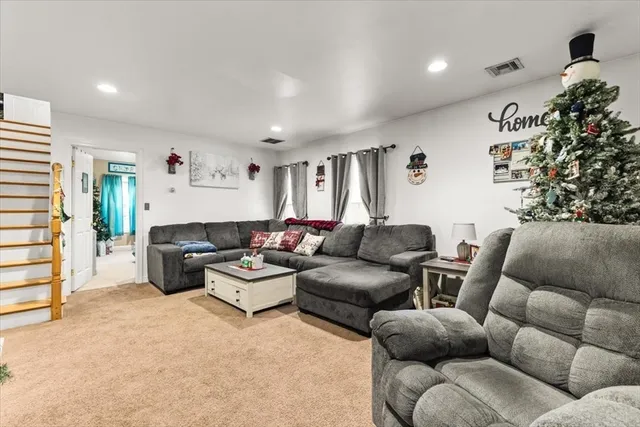 a living room with furniture cabinets and a window