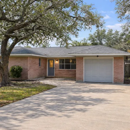a house that has a tree in front of it