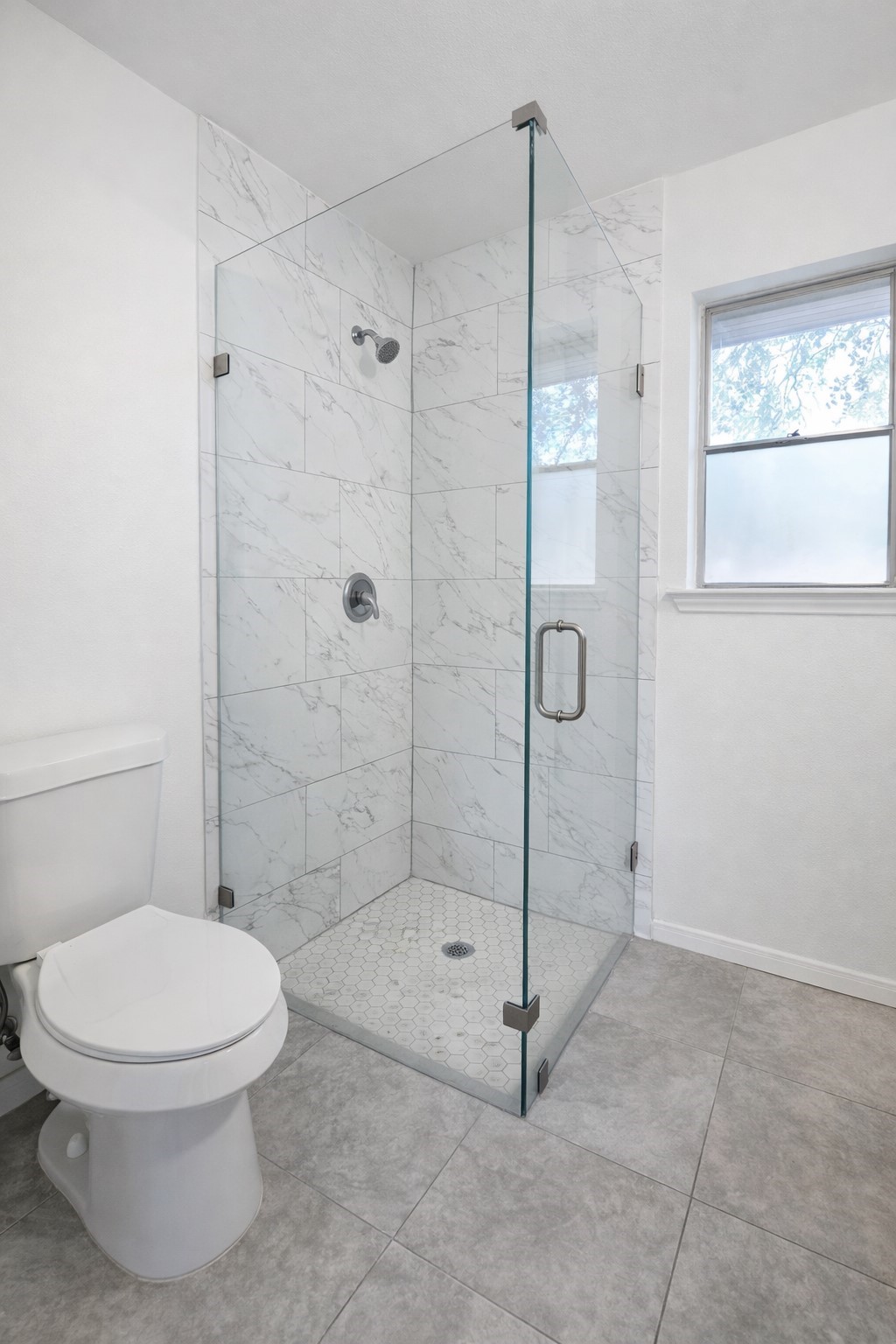 1820 Sunset Avenue Bay City, TX 77414 - Photo 12 of 26 Primary ensuite has updated fixtures, glass enclosed shower and tile floor.