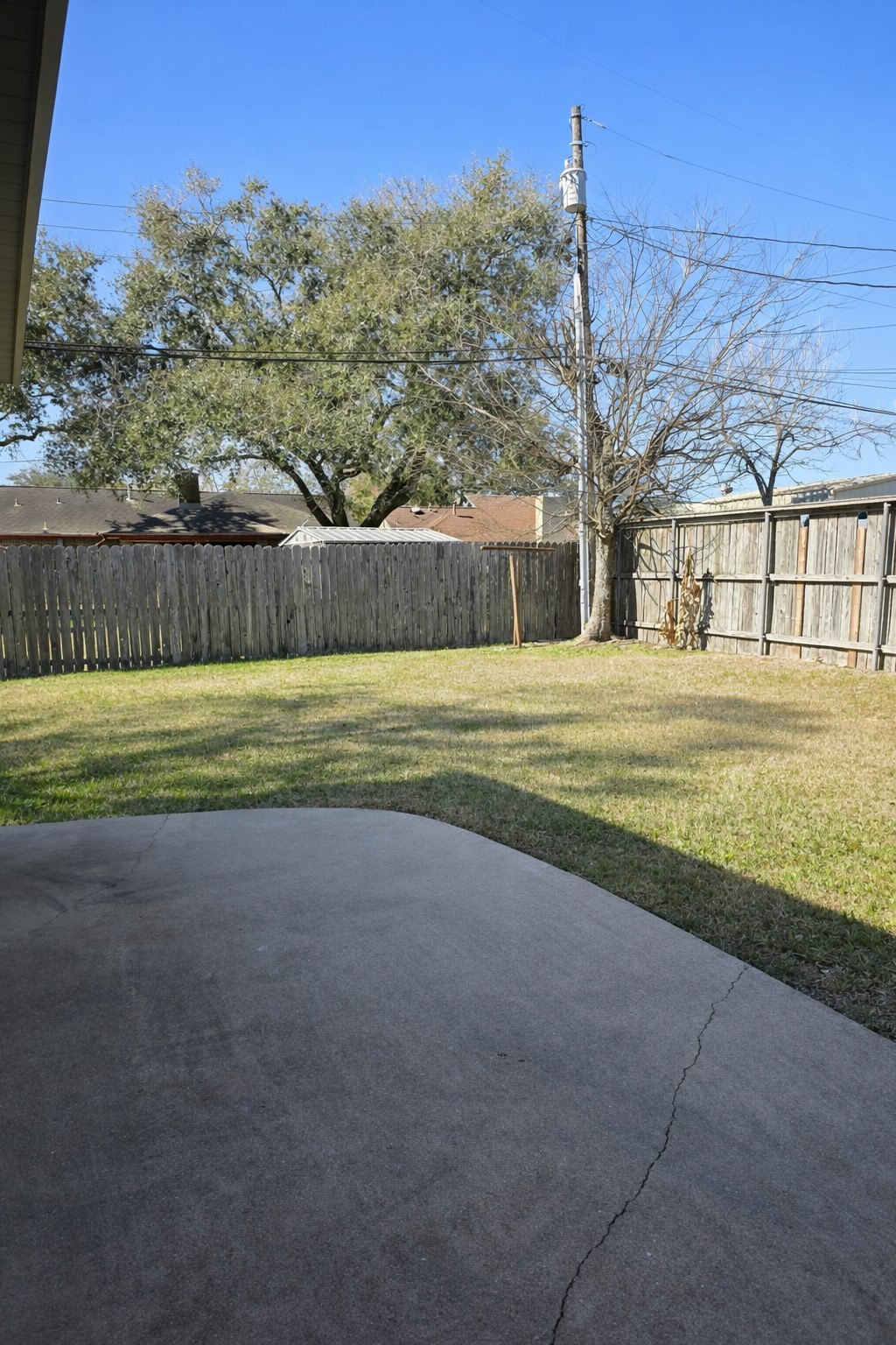 1820 Sunset Avenue Bay City, TX 77414 - Photo 18 of 26 Back porch and fully fenced backyard for outdoor entertaining.