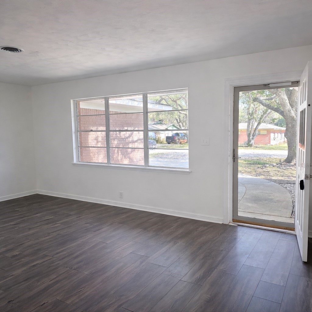1820 Sunset Avenue Bay City, TX 77414 - Photo 2 of 26 Front living area features laminate flooring and neutral paint.