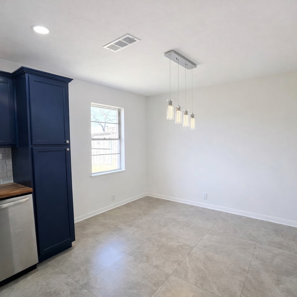 1820 Sunset Avenue Bay City, TX 77414 - Photo 7 of 26 A breakfast nook with updated lighting, tile floor, and window makes a great place to eat.