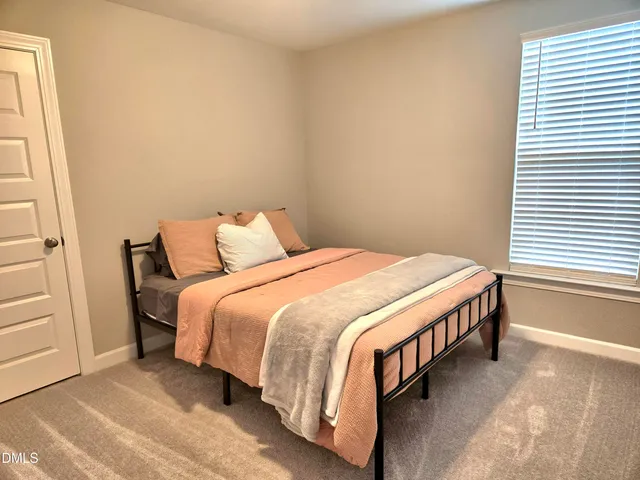 a bedroom with a bed and a cabinet