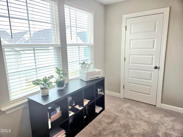 a bed room with a bed and a chair