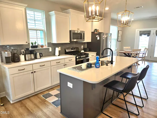 a kitchen with sink cabinets and dining table