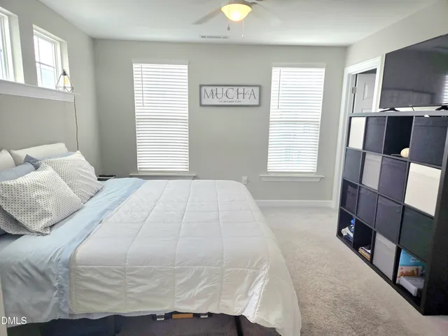 a bedroom with a bed and flat screen tv