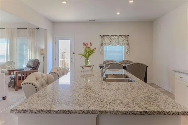 a bedroom with a bed a couch and dresser