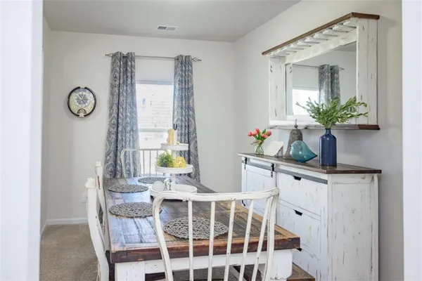 a dining room with furniture and window
