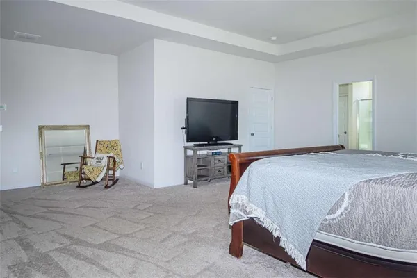a bedroom with a bed and flat screen tv