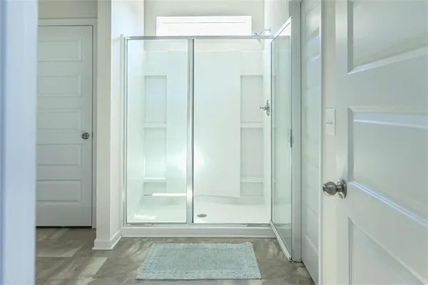 a bathroom with a glass door shower
