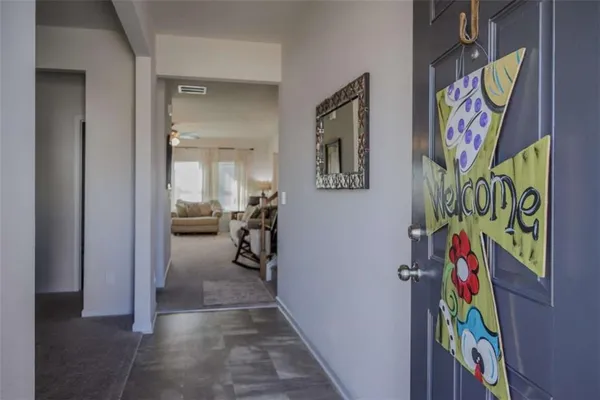 a view of a hallway with paintings on the wall