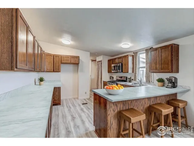 a kitchen with cabinets and wooden floor